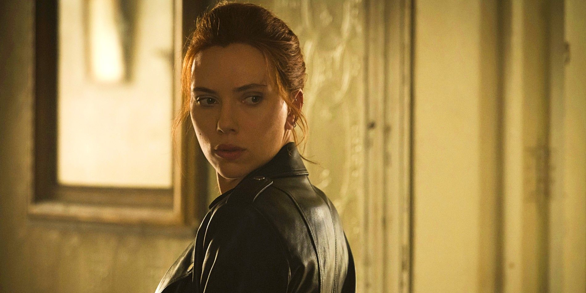 Natasha Romanoff turning back to look at someone in In Black Widow
