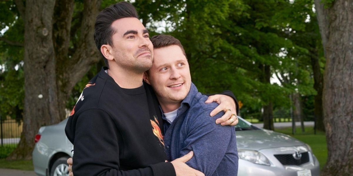 David and Patrick hugging while looking at their new house