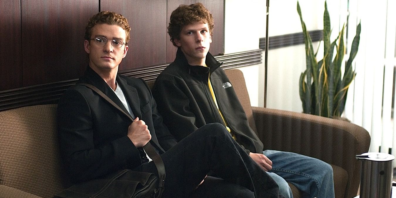 Sean and Mark sitting on a couch, waiting in The Social Network