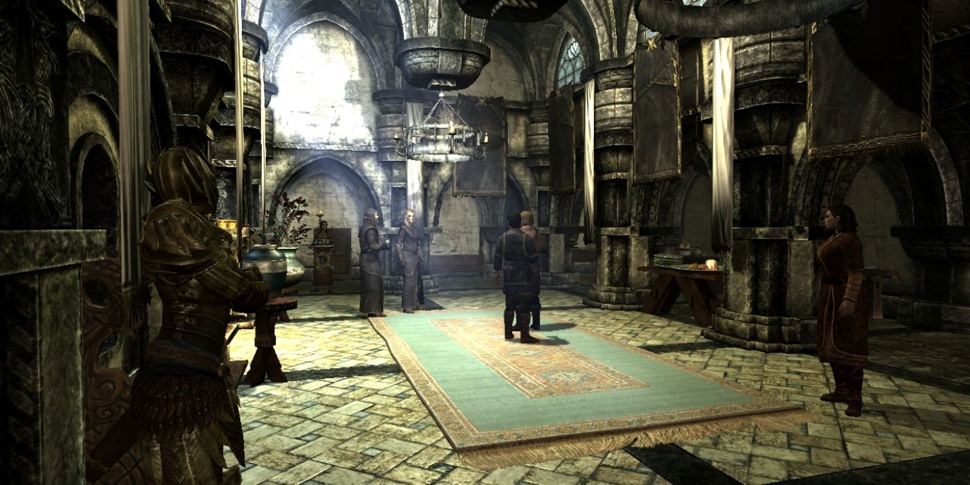 Two characters stand in the middle of a great room in Skyrim