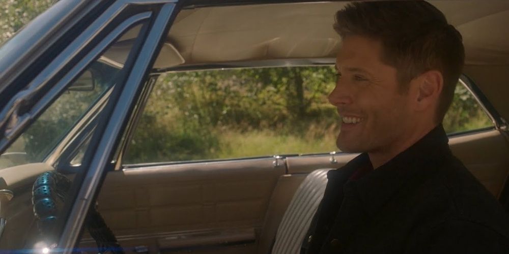 Dean smiles in the Impala in Supernatural.