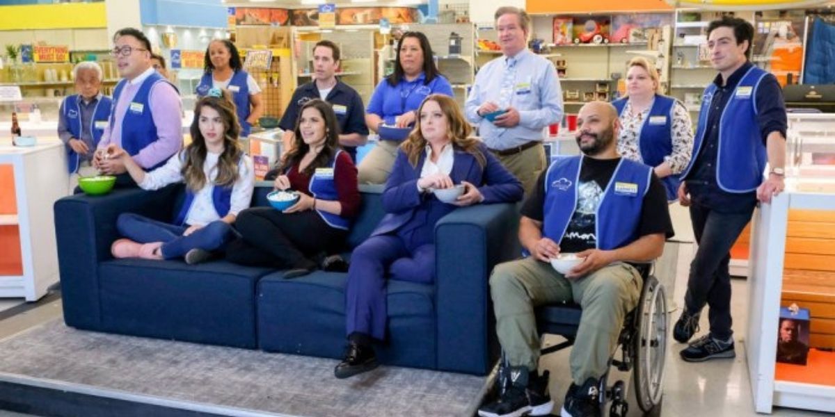 Superstore cast watching tv on a couch on the floor of Cloud 9