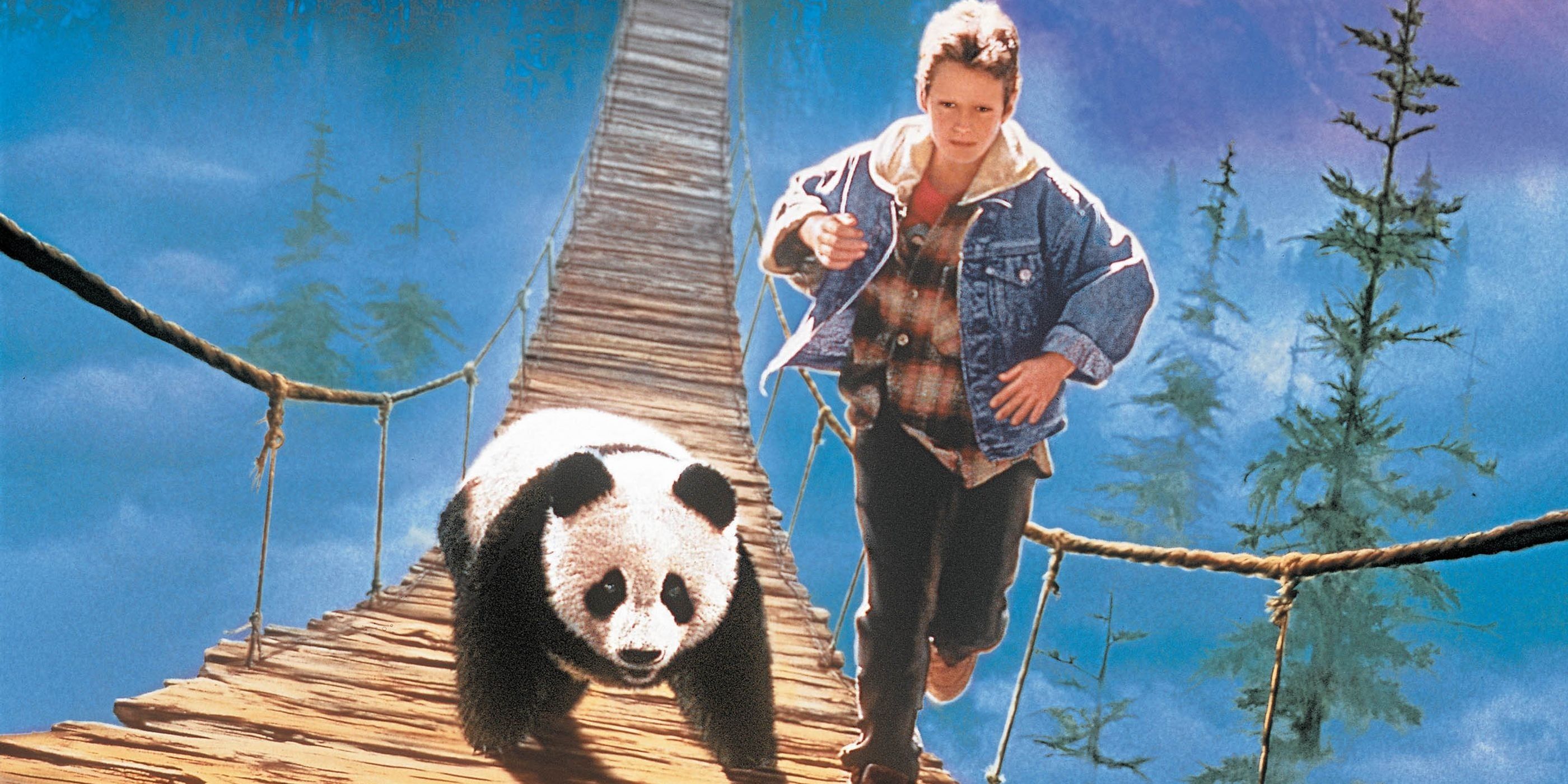 Boy running with panda along wooden bridge in The Amazing Panda Adventure