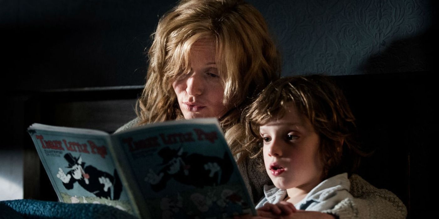 A young woman and a boy reading a book in The Babadook.