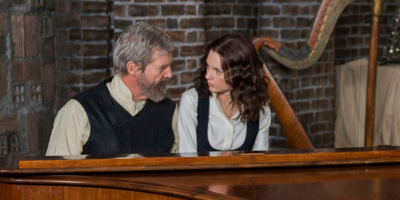 The Giver and Rosemary sitting at the piano in The Giver
