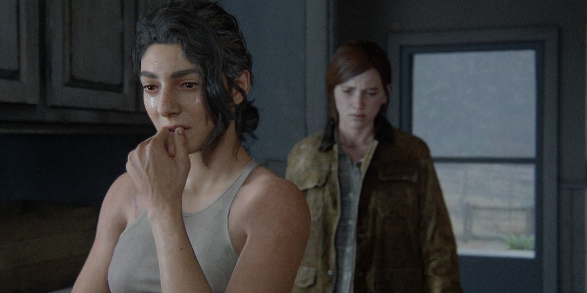 Dina cries while Ellie watches in The Last of Us 2