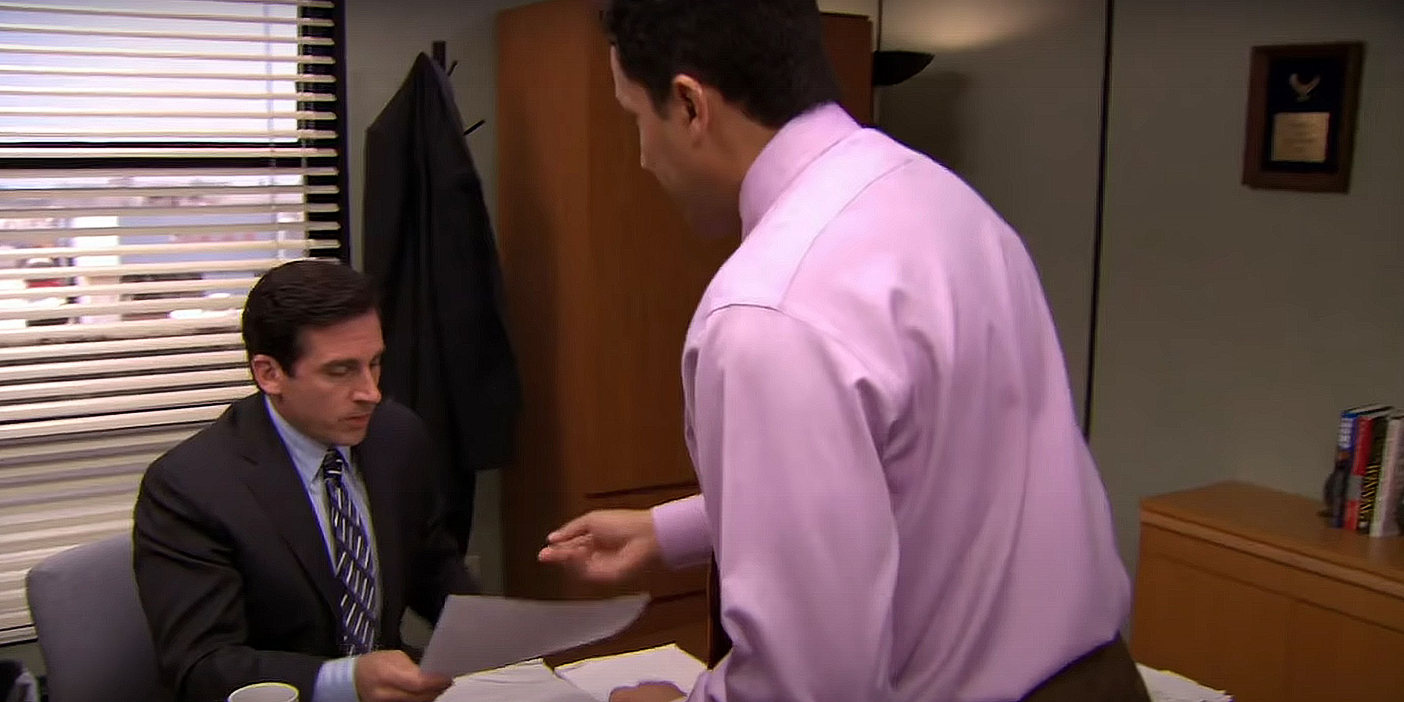 Oscar explaining a surplus to Michael in The Office.