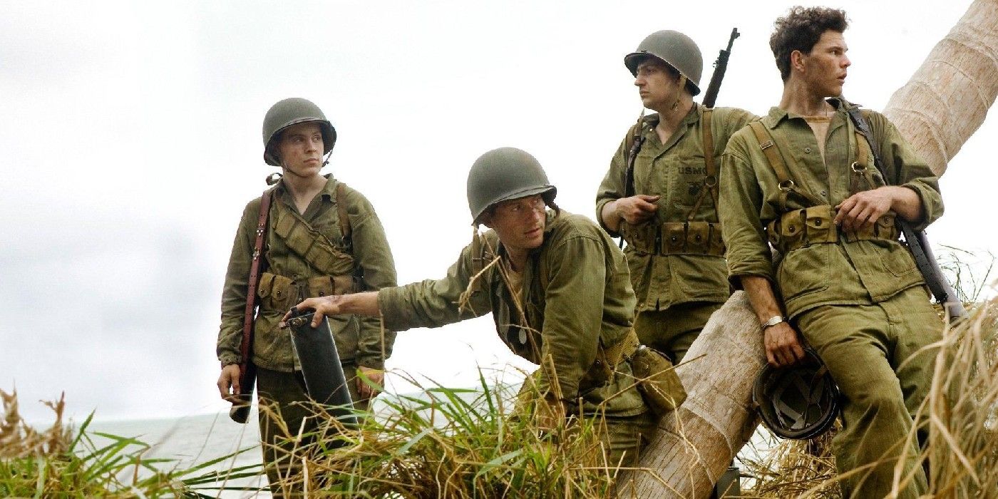 Soldiers leaning on a tree in The Pacific