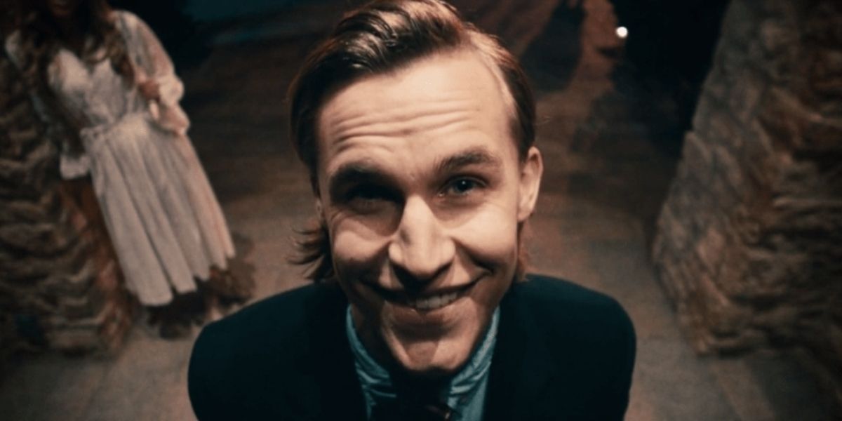 The Polite Leader smiling at the camera in The purge