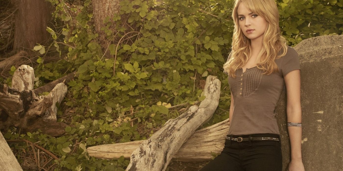 Cassie Blake stands in the forest in a promotional for The Secret Circle