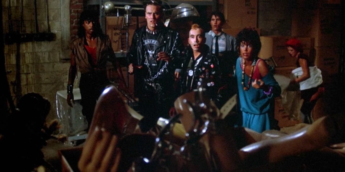 The main characters of Return of The Living Dead fighting defending themselves