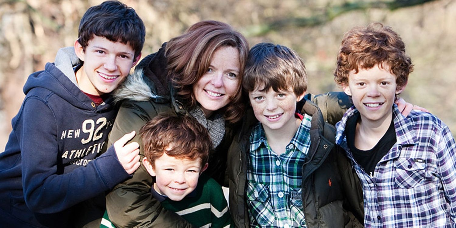 Tom Holland as a child in a family photo with his mother and brothers.