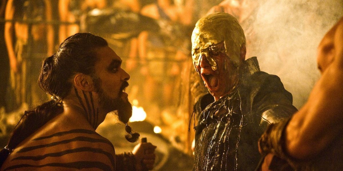 Khal Drogo looks on as Viserys burns to death