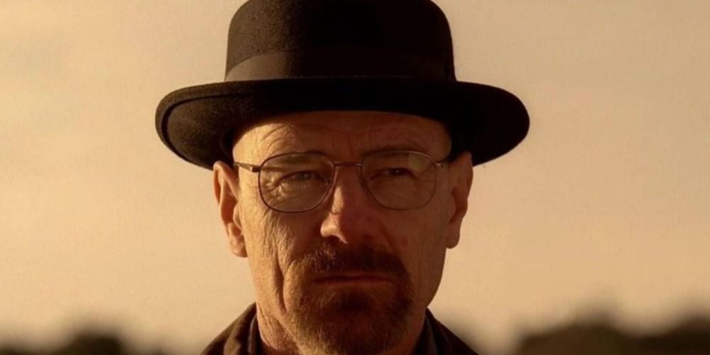 Walter White from Breaking Bad in the desert wearing a black hat.