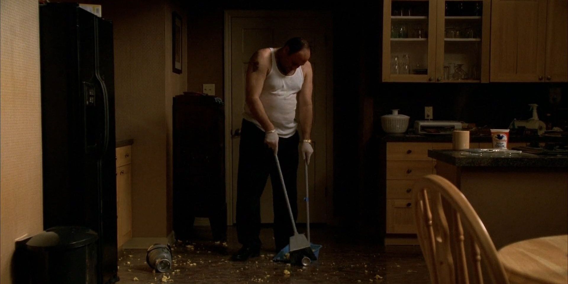 The Sopranos: Tony Soprano sweeping up garbage from the kitchen floor