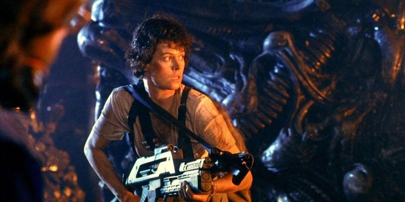 Ellen Ripley holds a gun while searching for Newt in the aliens' nest in Aliens.