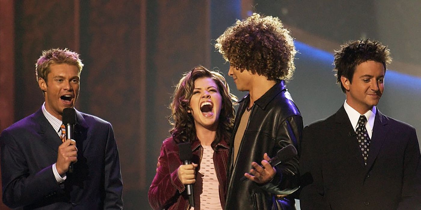 Kelly Clarkson and Justin Guarini after her win announcement, with Ryan Seacrest and Brian Dunkleman in the background.