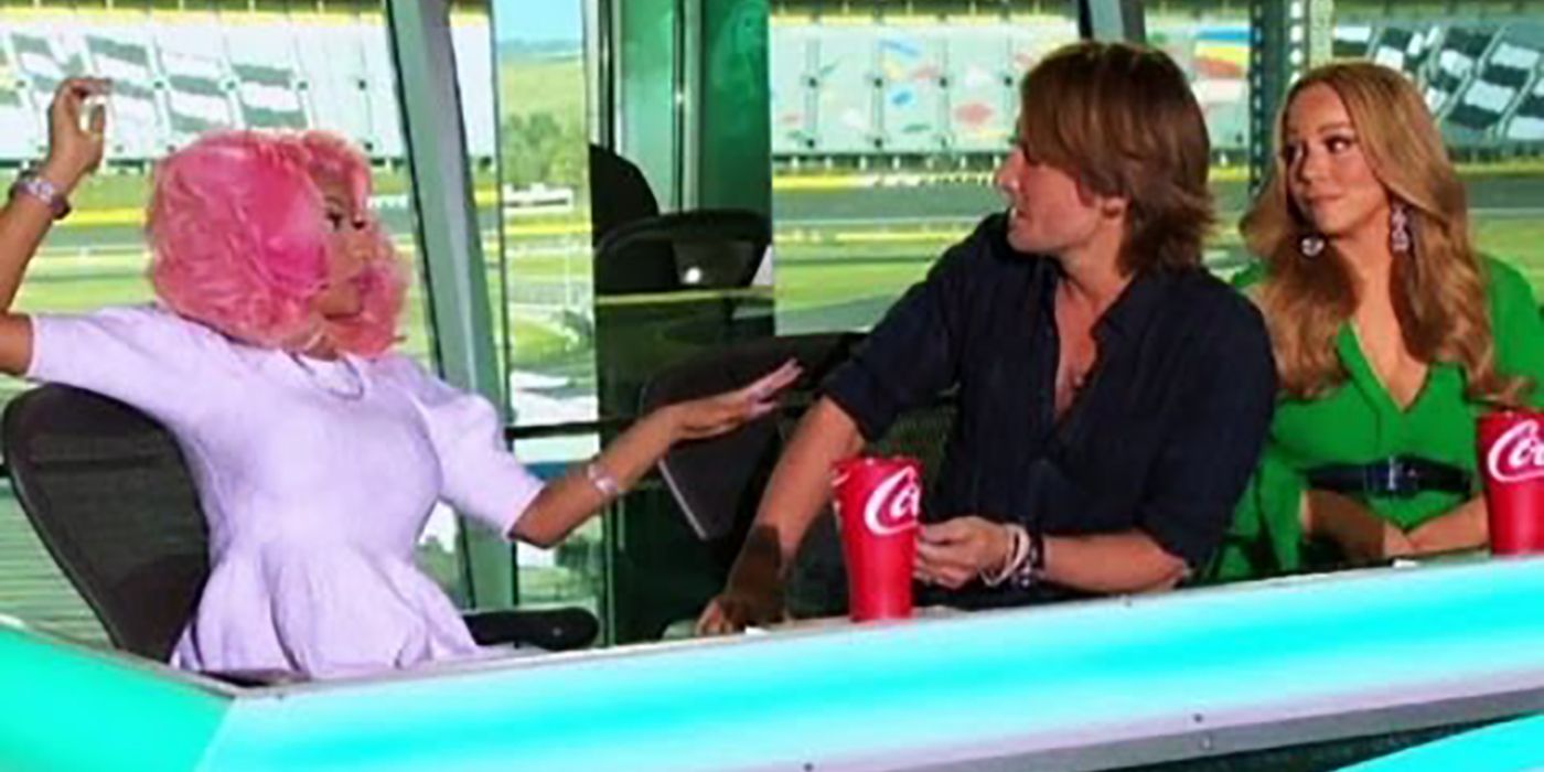 Mariah Carey and Nicky Minaj arguing at the American Idol judges table.