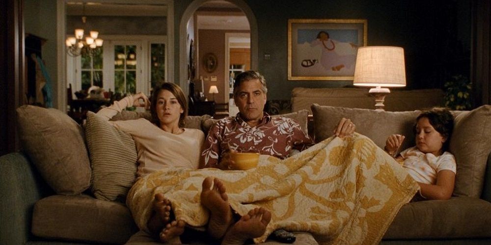 Alex, Matt, and Scottie sit on couch in The Descendants