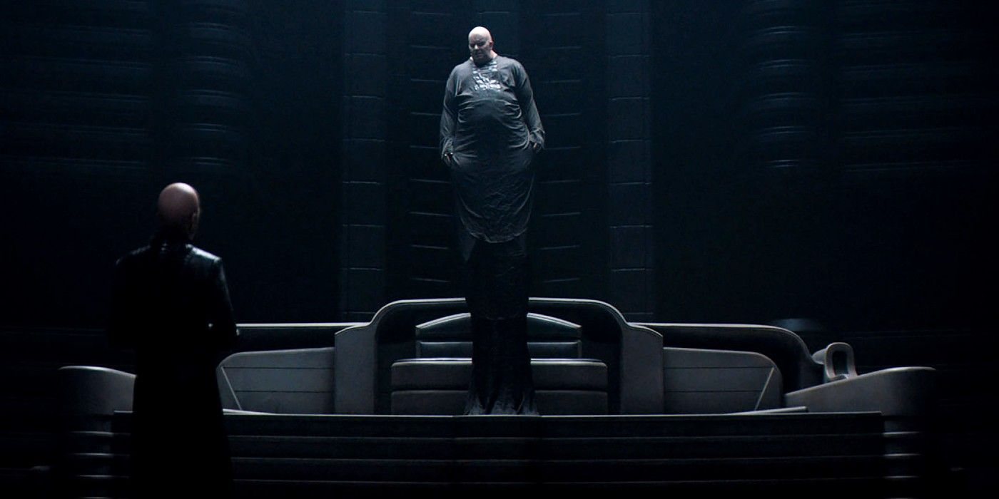 Baron Harkonnen standing up from his chair facing his mentat in Dune (2021).