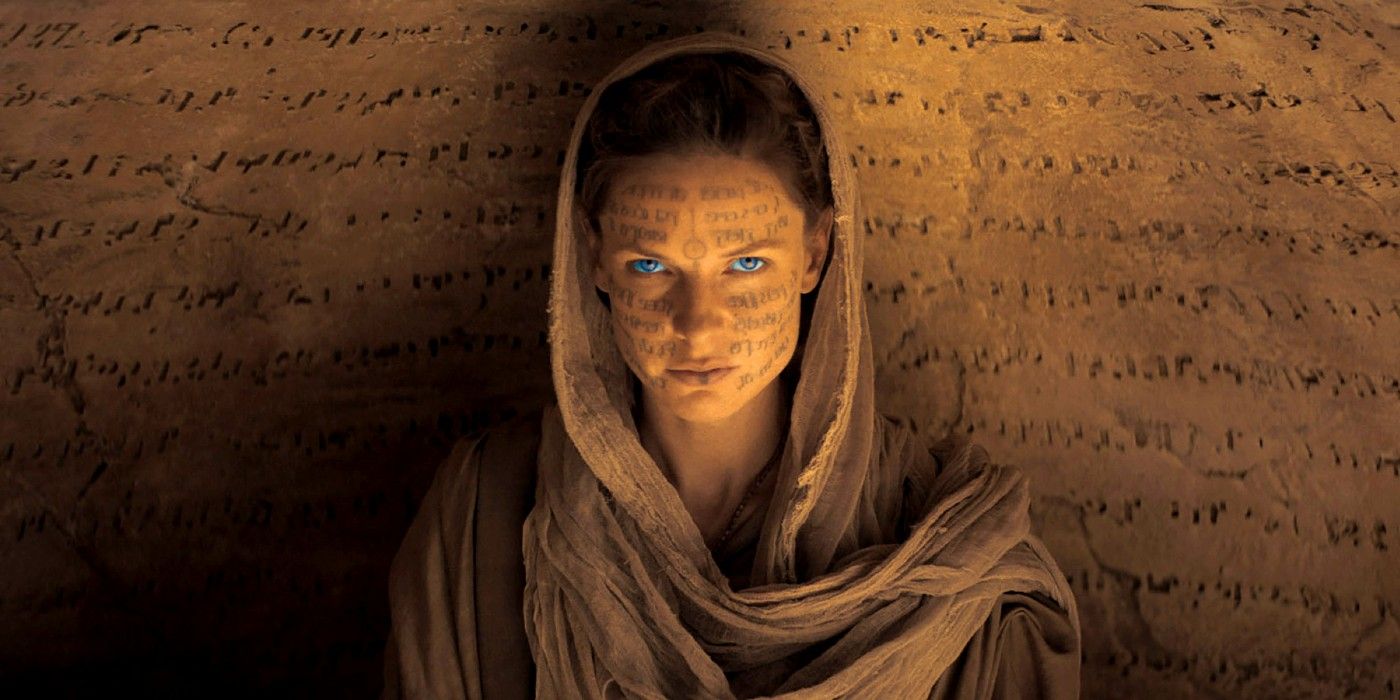 Lady Jessica staring at the camera with text all over her face and the wall in Dune (2021).