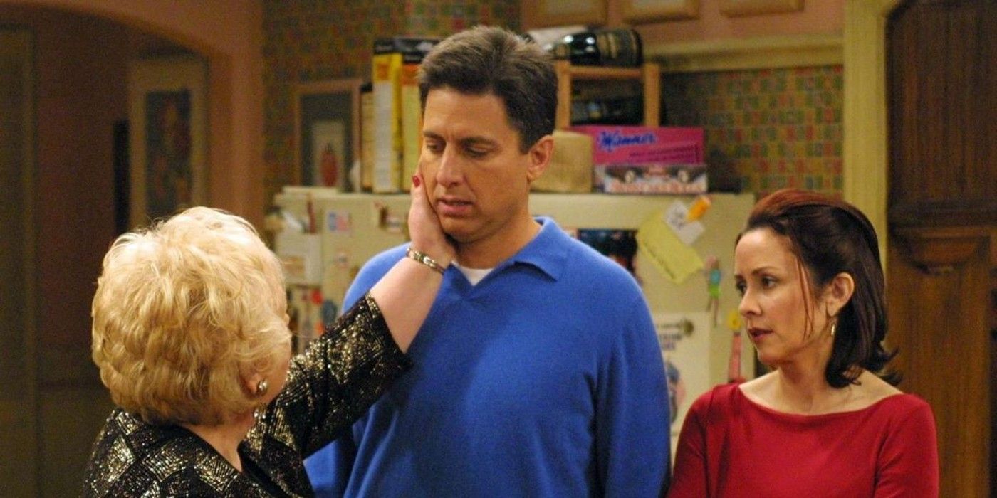 Raymond's mom touching his face while standing next to his wife on Everybody Loves Raymond