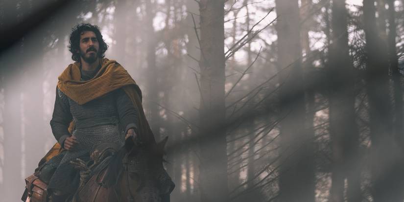 Dev Patel as Gawain on horseback in the forest in The Green Knight