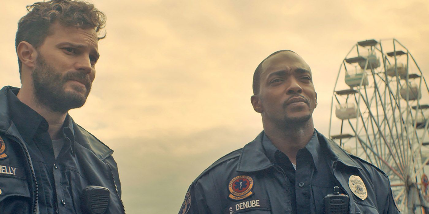 Jamie Dornan and Anthony Mackie in a scene from Synchronic wearing paramedic uniforms.