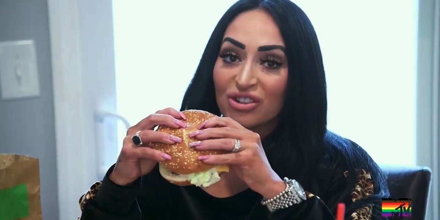 Angelina eating a burger on Jersey Shore.