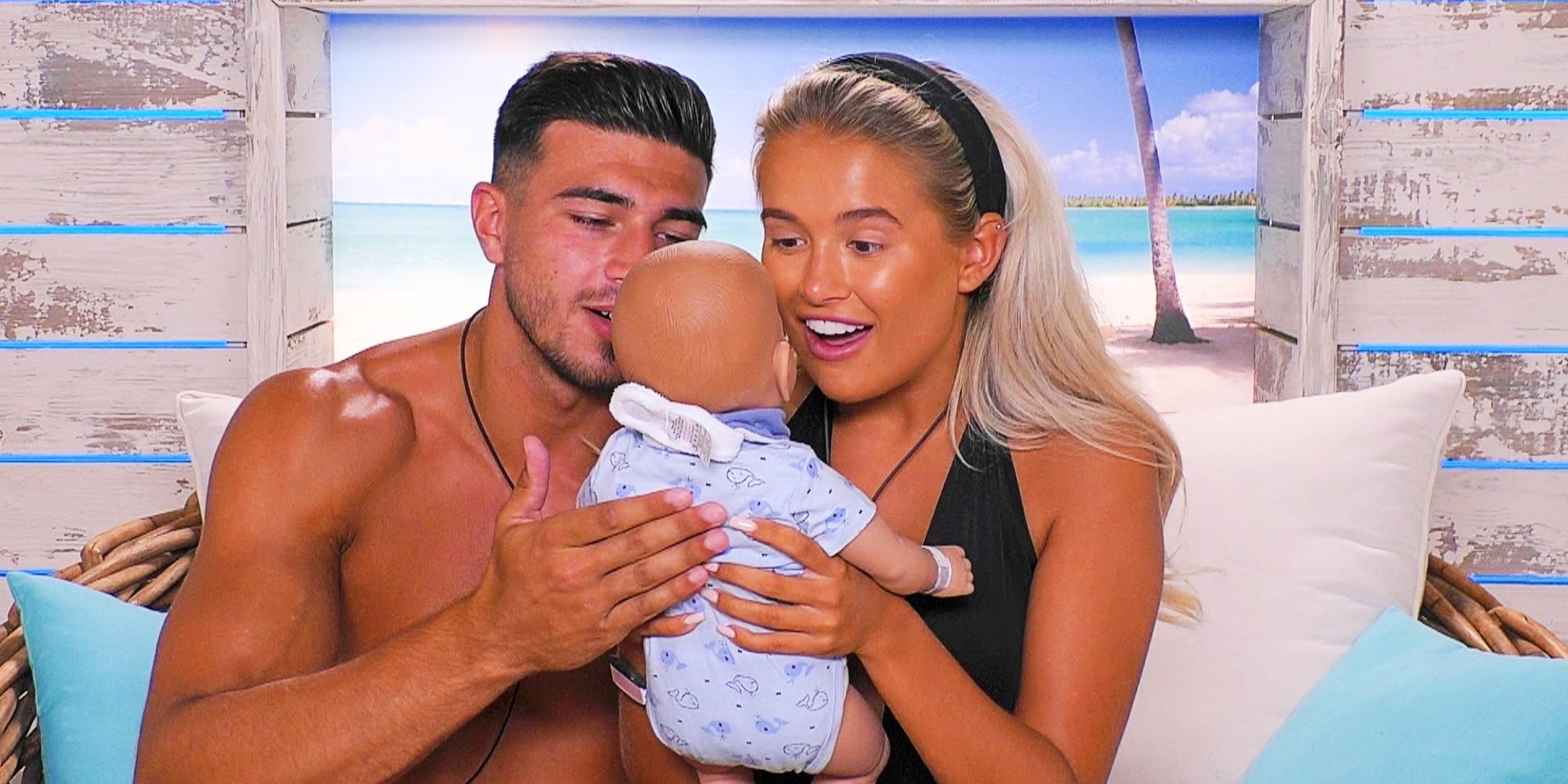 Love Island U.K. contestants Tommy and Molly-Mae with their training baby