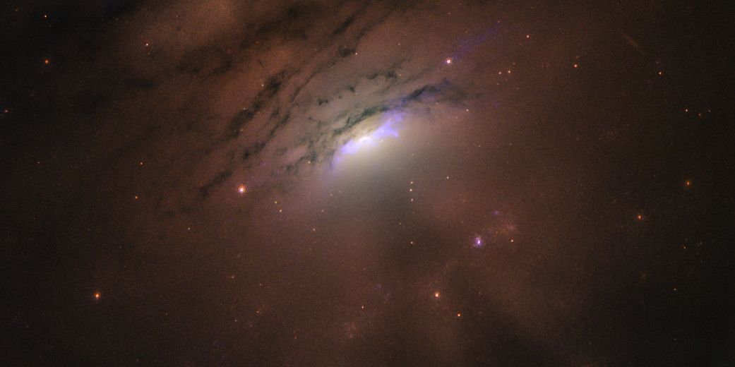 Photo from Hubble, showing a faraway galaxy casting shadows in space