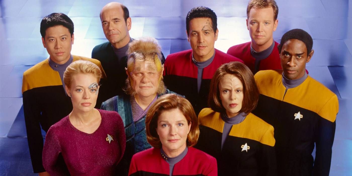 The cast of Star Trek: Voyager posing together and looking up