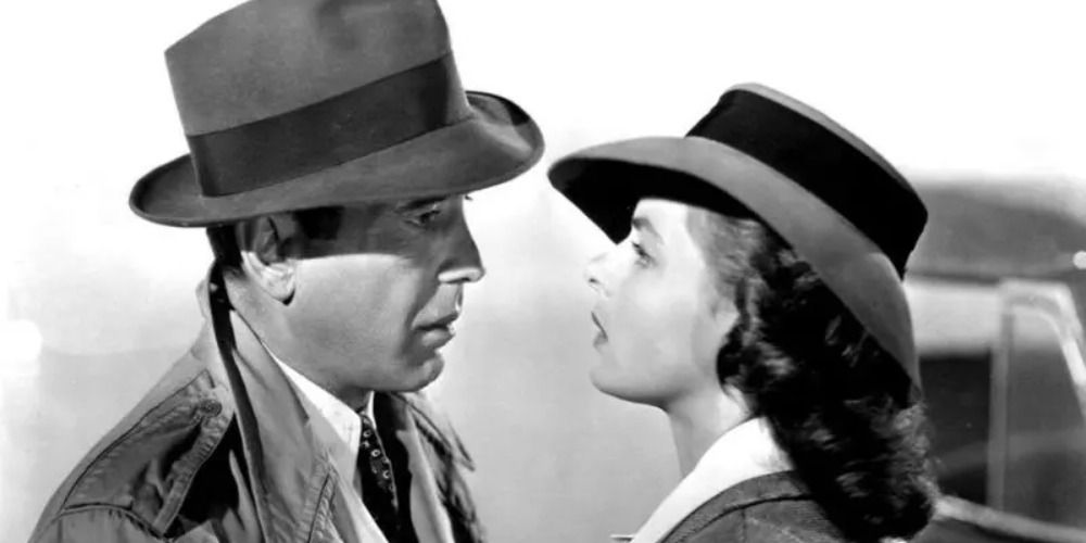 the main characters of Casablanca staring at each other lovingly the picture is in black and white both are wearing hats