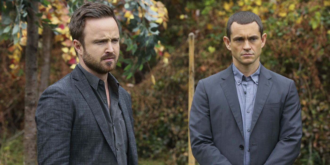 Aaron Paul standing with another man from the Hulu series The Path.