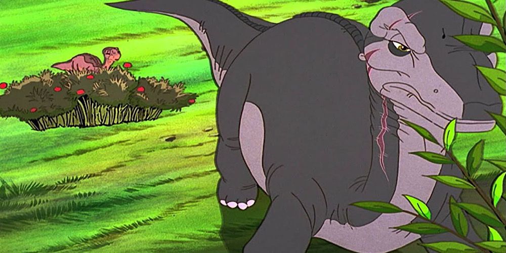 Littlefoot hides from a dinosaur much bigger than him in The Land Before Time VI: The Secret Of Saurus Rock