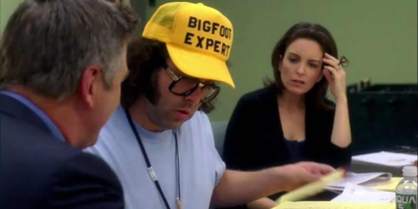 Frank wearing a hat that says Bigfoot Expert in 30 Rock