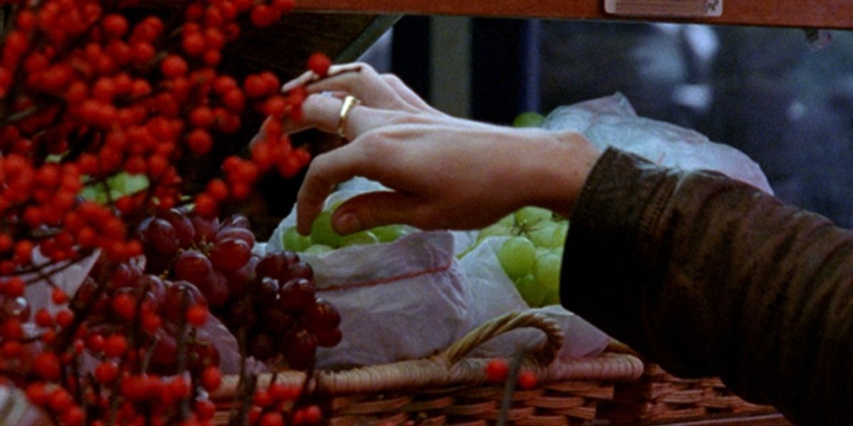 A Hand Reaches For Some Grapes In The Pleasure Of Being Robbed