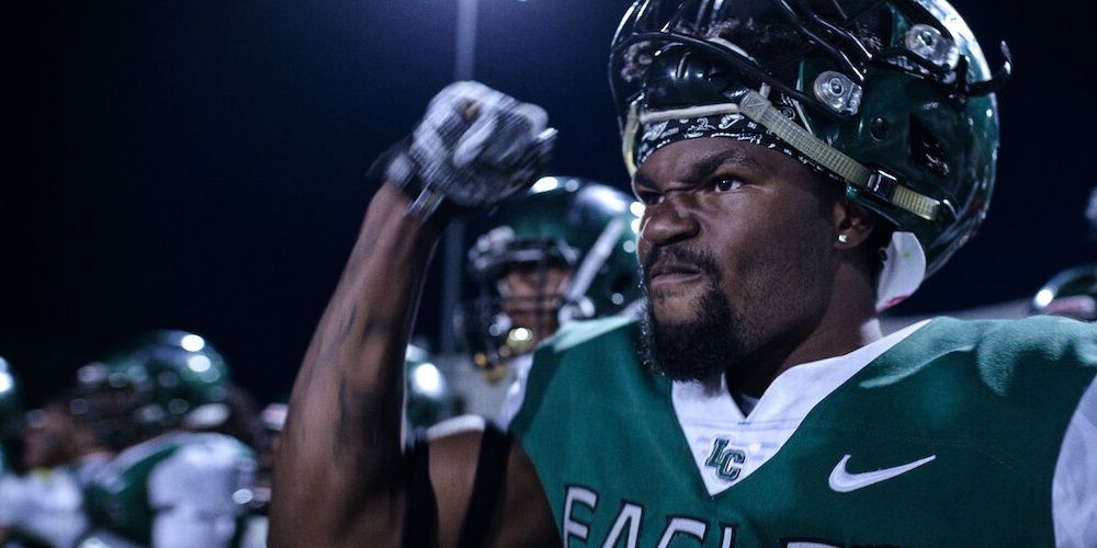A football player raising his clenched fist in a still from Last Chance U Cropped