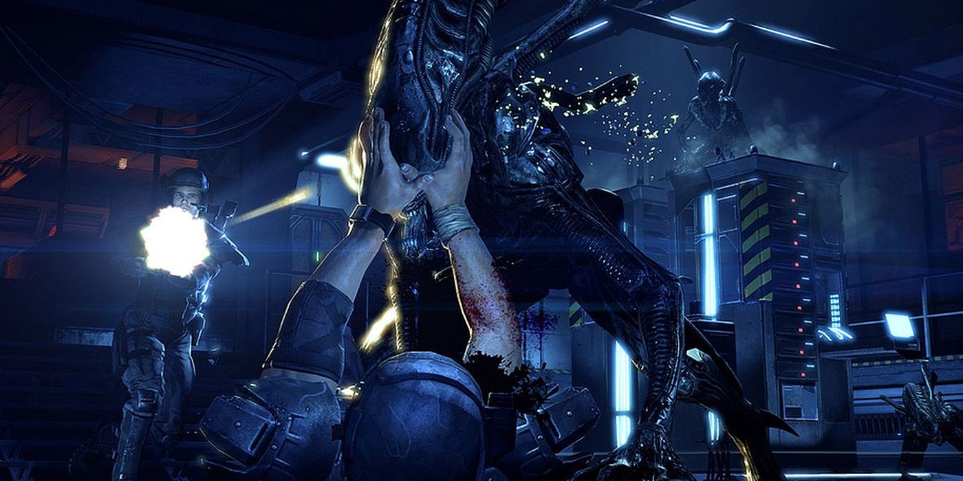 A marine tries to prevent an alien from killing him in Aliens: Colonial Marines