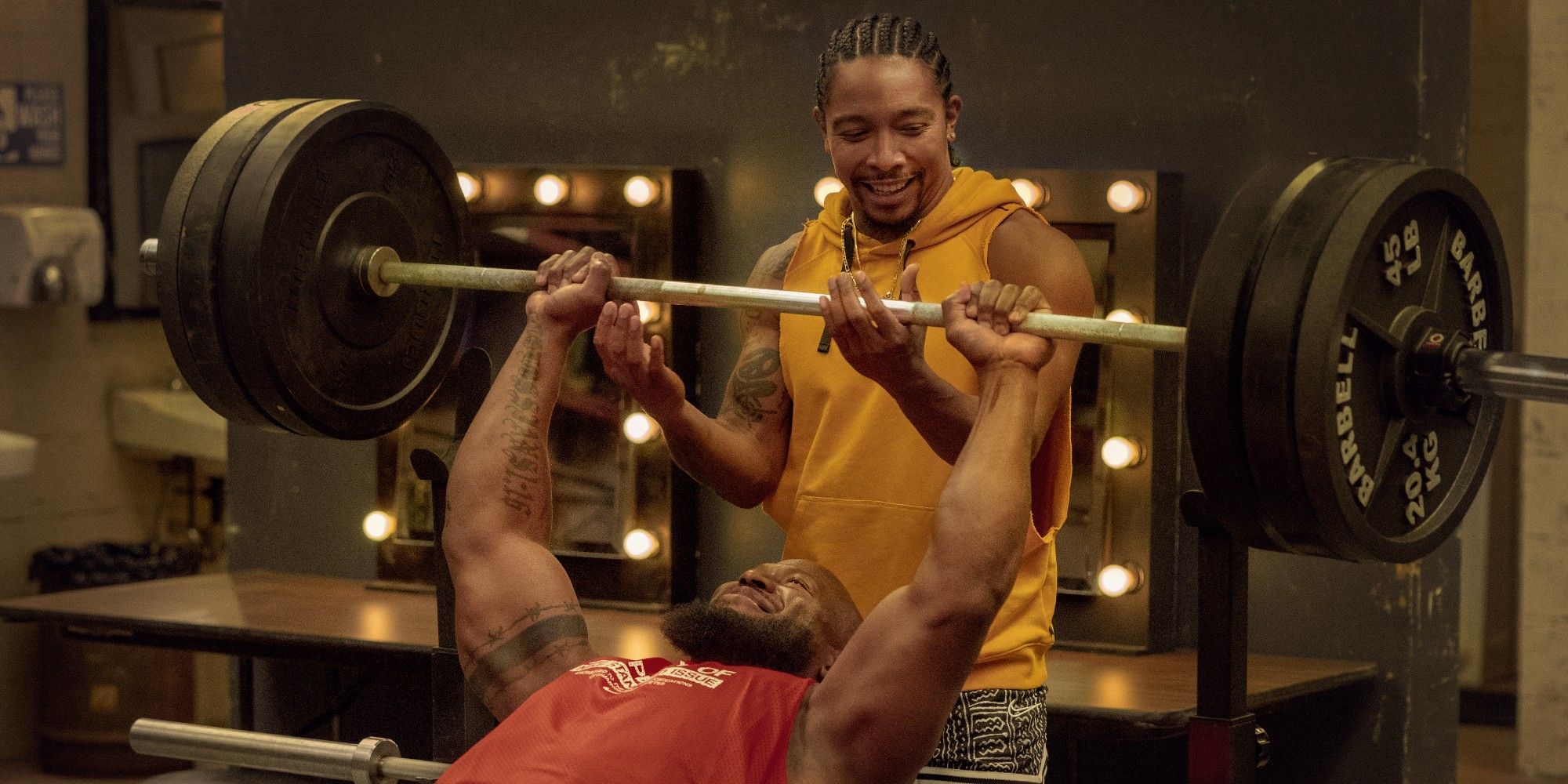 Allen Maldonado as Rooster helping someone train in the gym in Heels