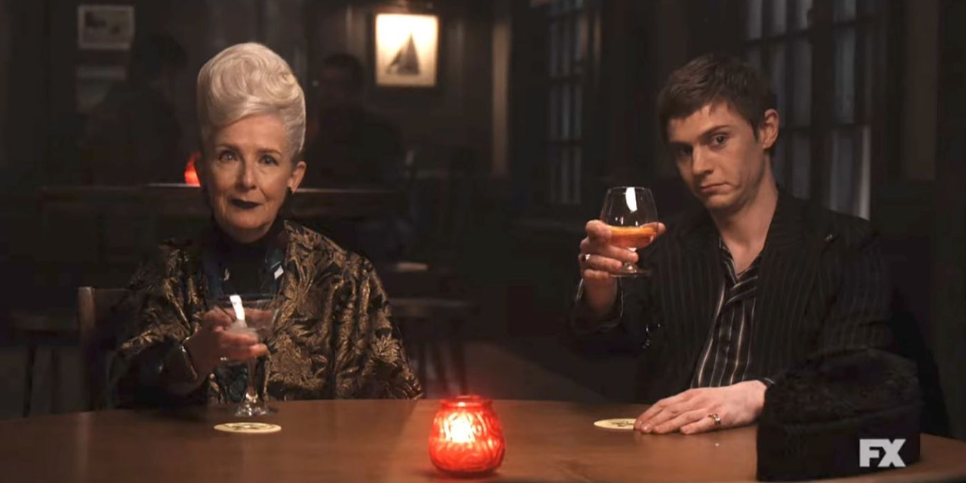 Frances Conroy and Evan Peters' characters toasting at someone in American-Horror-Story-Double-Feature