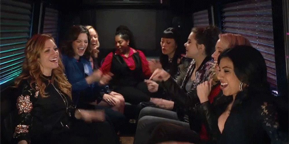 An image of the Barden Bellas singing in the back of a van in Pitch Perfect 3