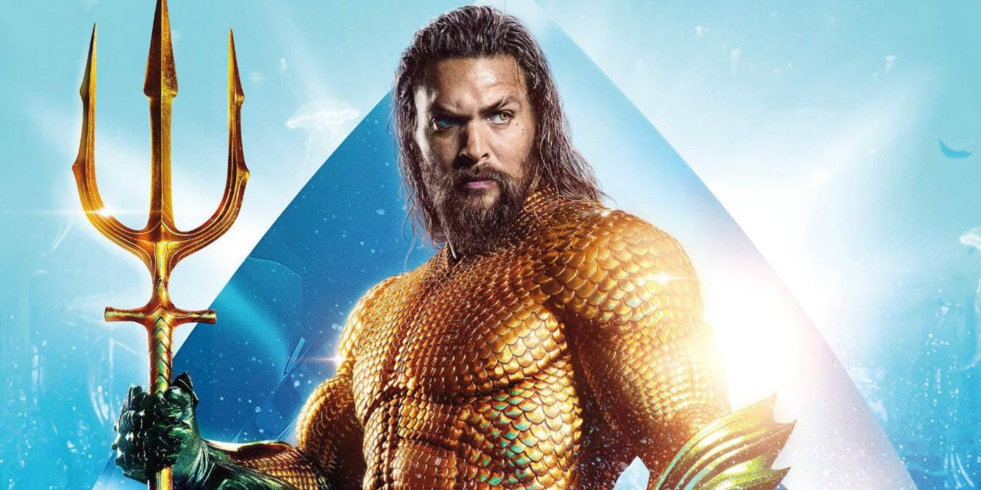 Aquaman standing with his trident in movie.