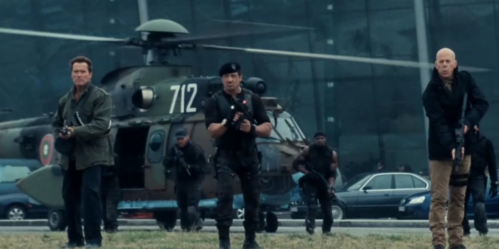 Trench, Barney, Ross, and Church with gun in airport attack The Expendables 2