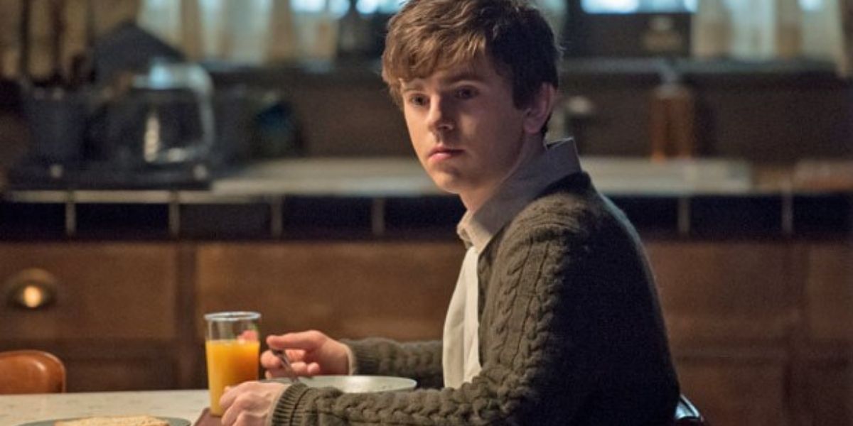Norman drinking juice at the kitchen table in Bates Motel