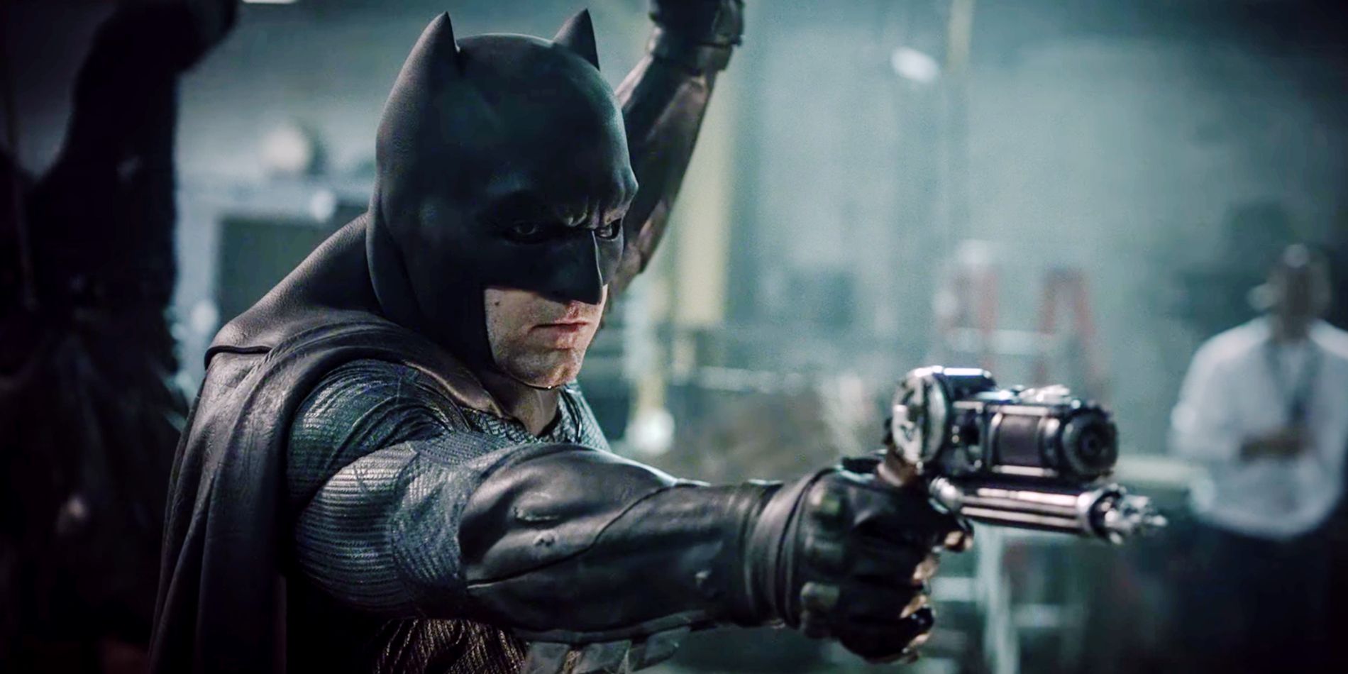 Ben Affleck's Batman wielding his grapnel gun in Batman V Superman: Dawn Of Justice