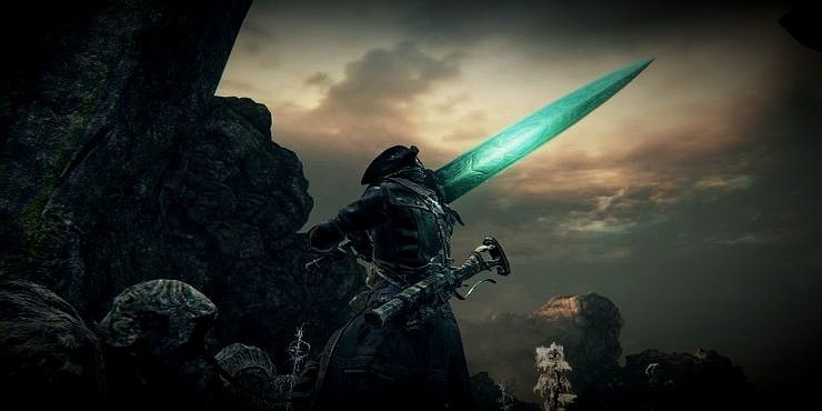 A hunter holding the glowing Ludwig's Holy Blade in Bloodborne