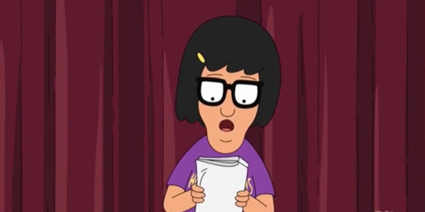 Tina on stage reasing a note and singing in Bob's Burgers