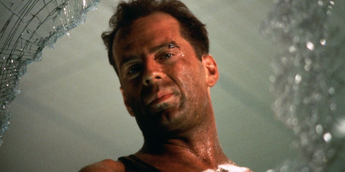 John McClane looking out a broken window in Die Hard