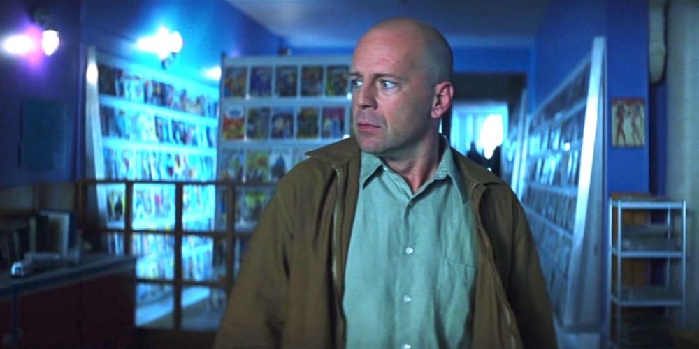 Bruce Willis in Unbreakable, standing in a comic book store